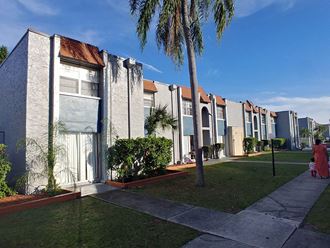 a row of houses with palm trees in front of them