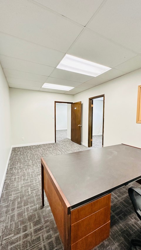 A conference room with a long table and chairs.