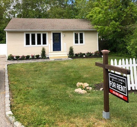 a for rent sign in front of a house