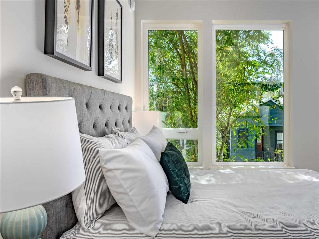 Bedrooms with oversized windows and natural light at Acqua Apartments.
