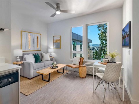 a living room with a couch and a table and a window