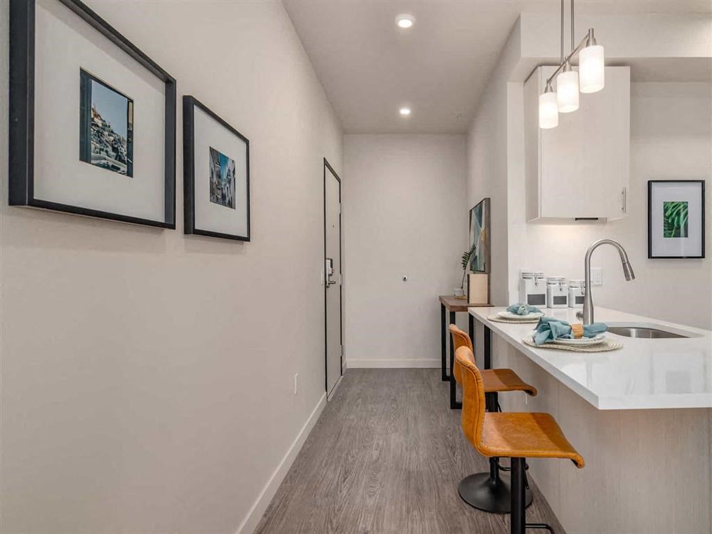 Quartz countertops in kitchens and stainless steel appliances at Acqua Apartments.