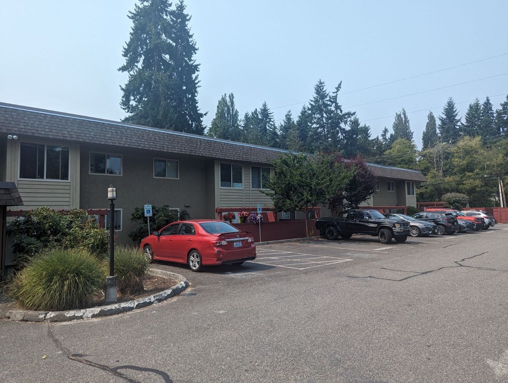 a parking lot with cars in front of a building