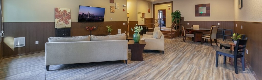 a living room with a couch and chairs and a table