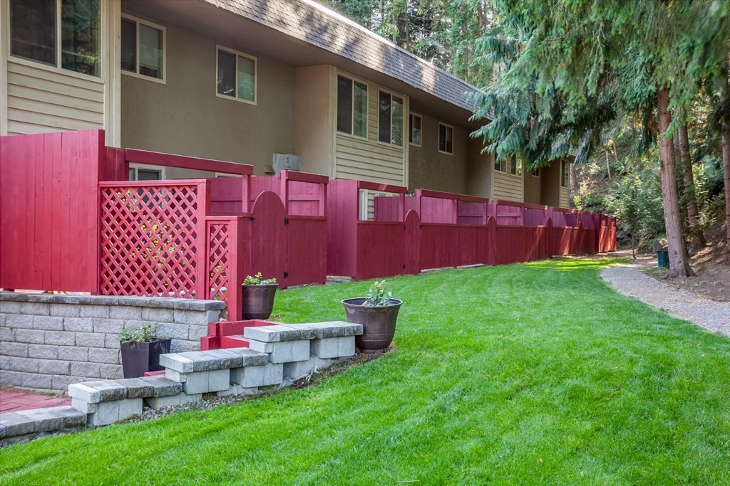 a row of red fences in front of a house