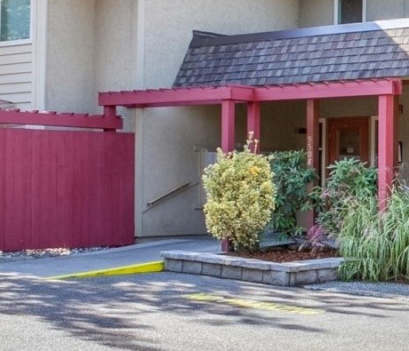 a house with a red porch and a driveway