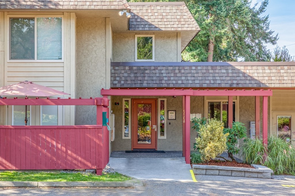 the front entrance of a house with a red porch