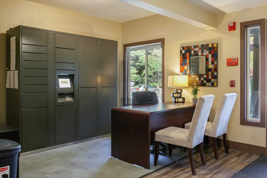 a home office with a desk and chairs and a window