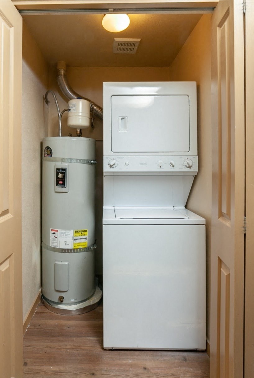 a washer and dryer in a small room next to a water heater