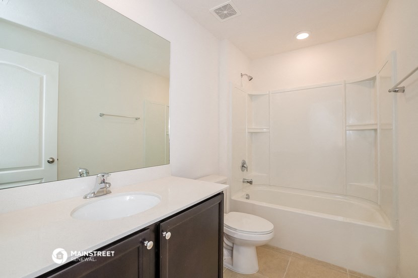 a bathroom with a sink and a toilet and a shower