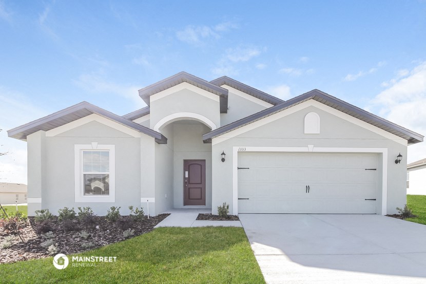 a white house with a driveway and a garage door
