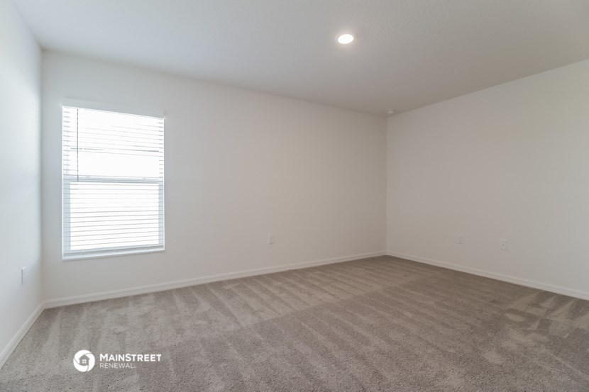 a room with a carpeted floor and a window