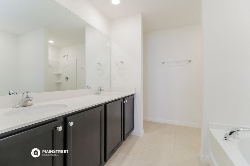 a bathroom with two sinks and a large mirror