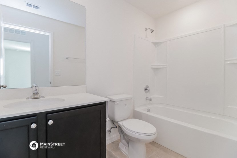 a bathroom with a sink toilet and a bath tub