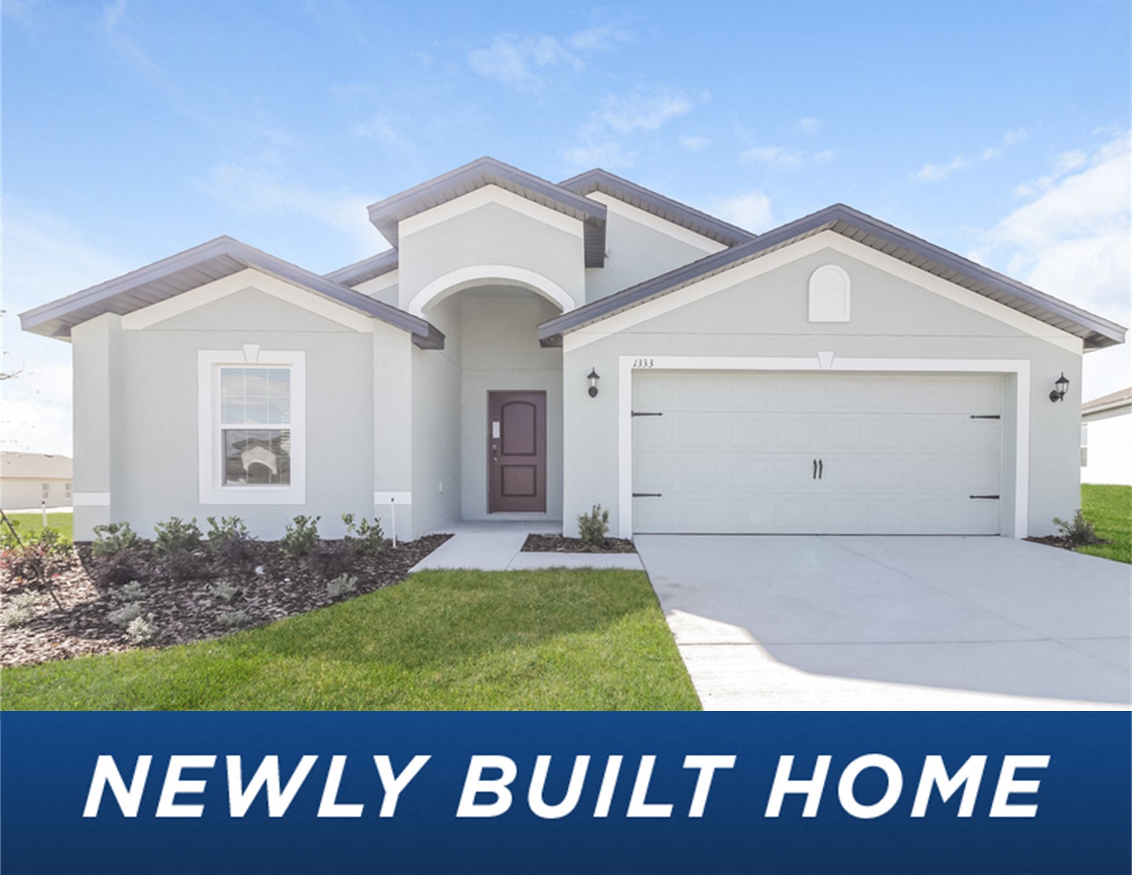 a new build home in front of a lawn and a driveway