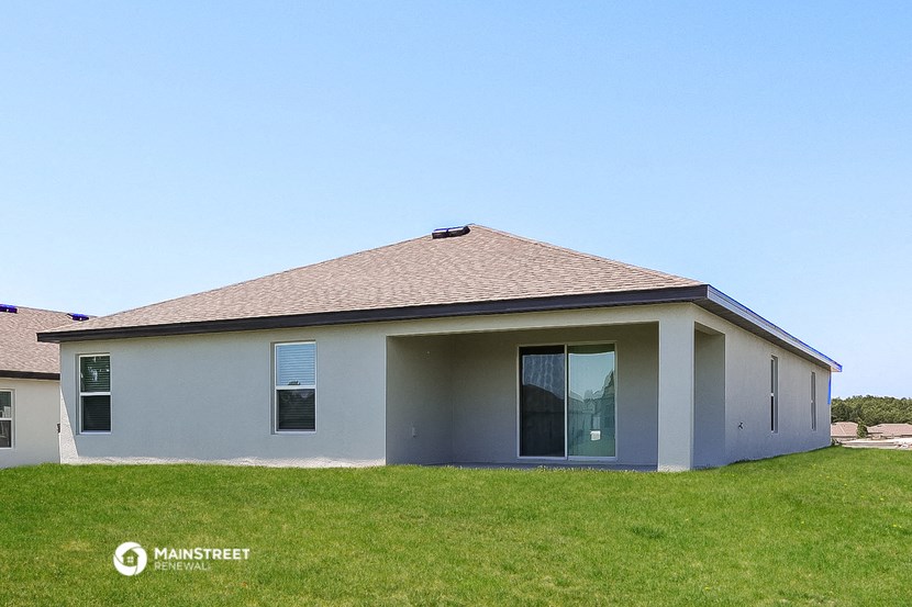 a small white house with a grassy yard