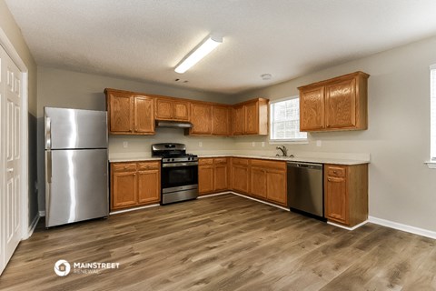 a kitchen with wooden cabinets and stainless steel appliances