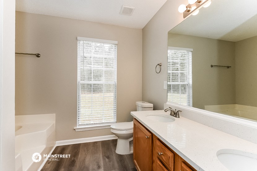 a bathroom with a toilet sink and a mirror