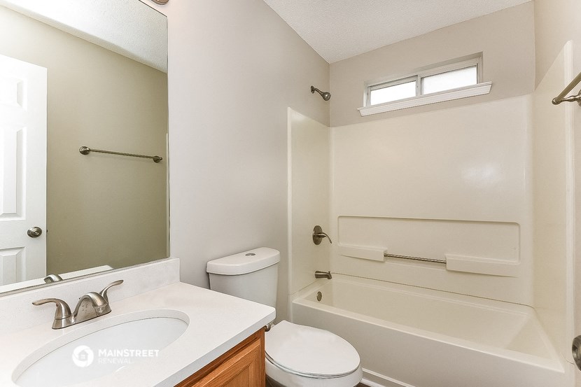a bathroom with a sink toilet and a bath tub