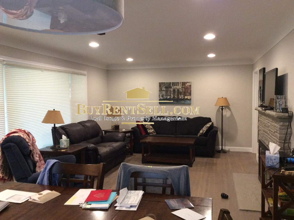 a living room with couches and chairs and a table