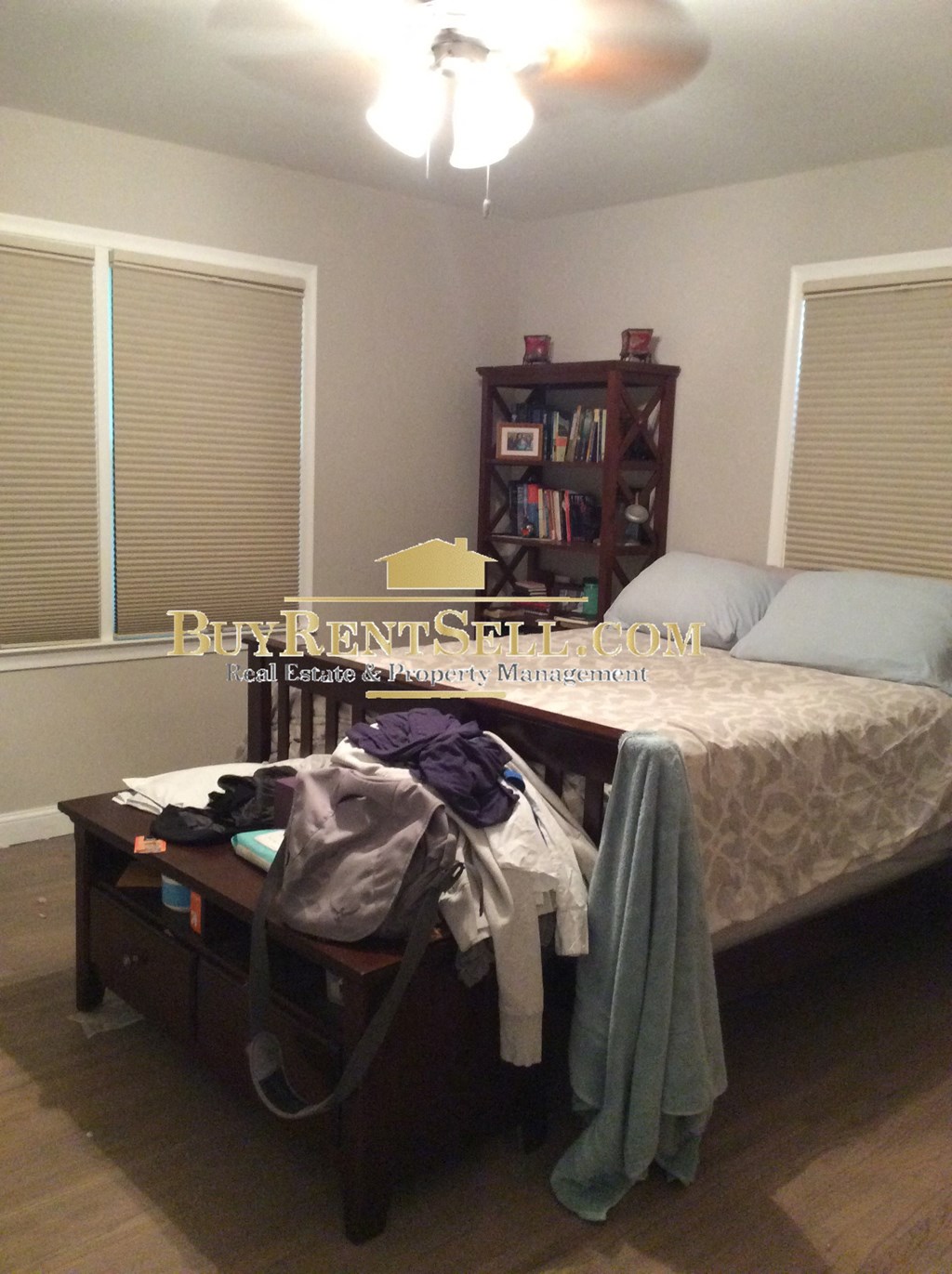 a small bedroom with a bed and a suitcase