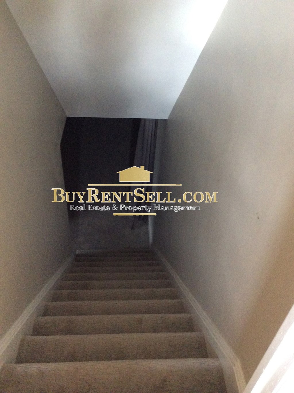 a stair case with a sign on the top of the stairs