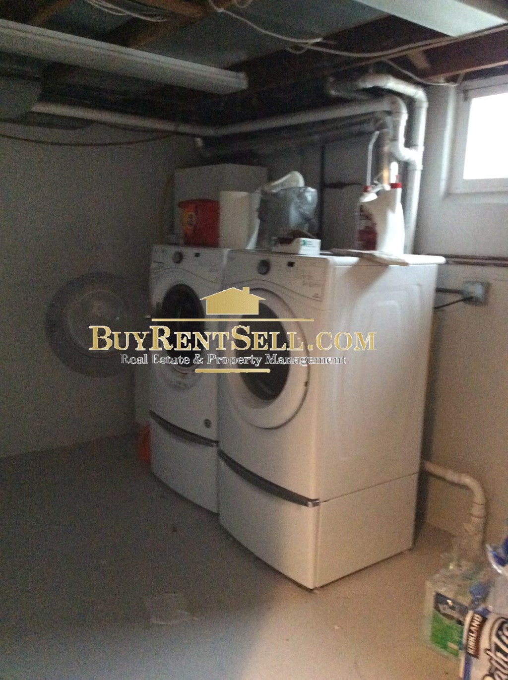 a white washer and dryer in a garage