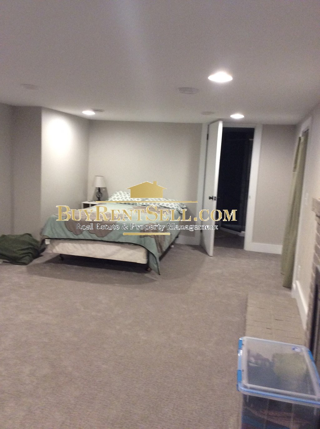 a room with a bed in the middle of a room