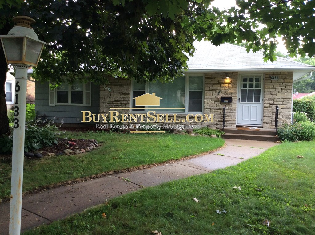 the front of a brick house with a sign that reads burrents solicitors