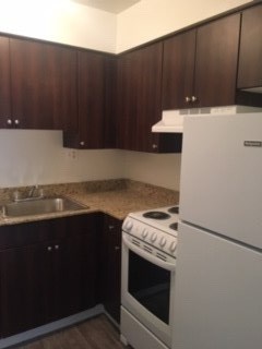 a kitchen with a stove and a refrigerator