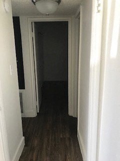 a hallway with a door open and a dark room