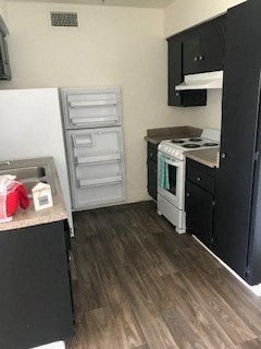 a small kitchen with a stove and a sink