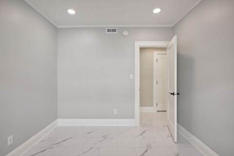 A room with a marble floor and a door.