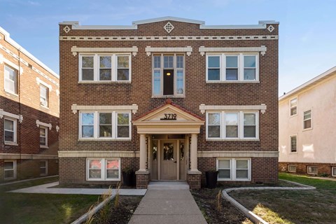 A brick building with the number 3718 on the front.