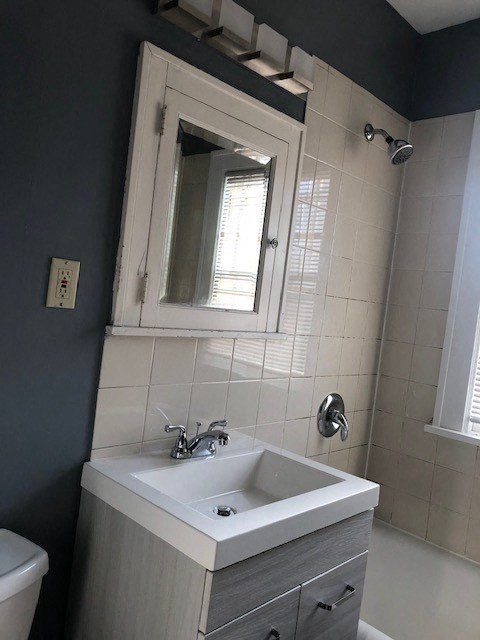 a bathroom with a white sink and a mirror