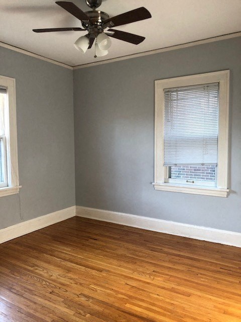 an empty room with a ceiling fan and a window