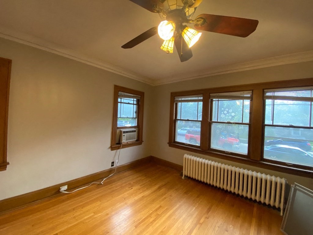 the living room of an empty house with a ceiling fan