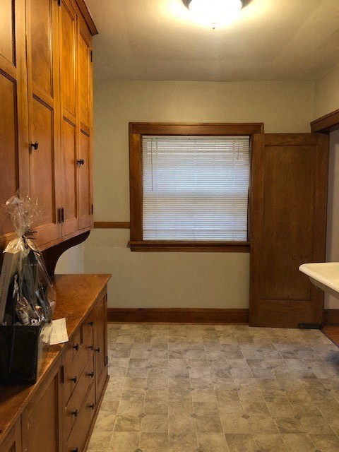 a kitchen with wooden cabinets and a window