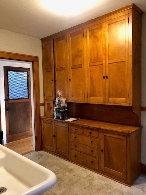 a bathroom with wooden cabinets and a bath tub