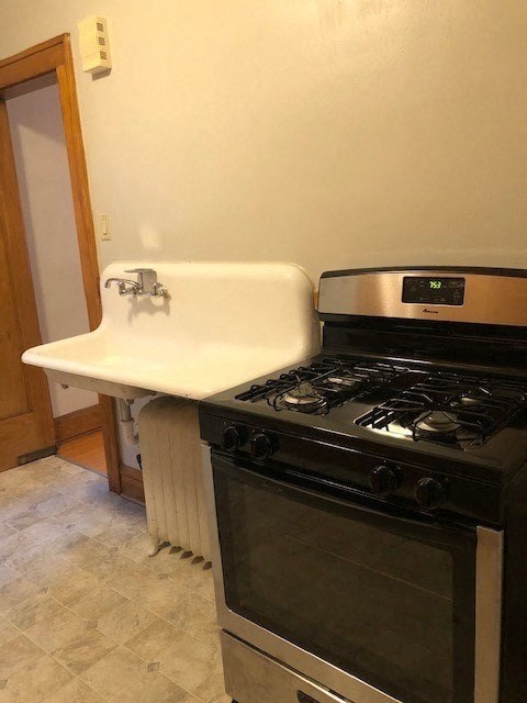 a kitchen with a stove and a sink