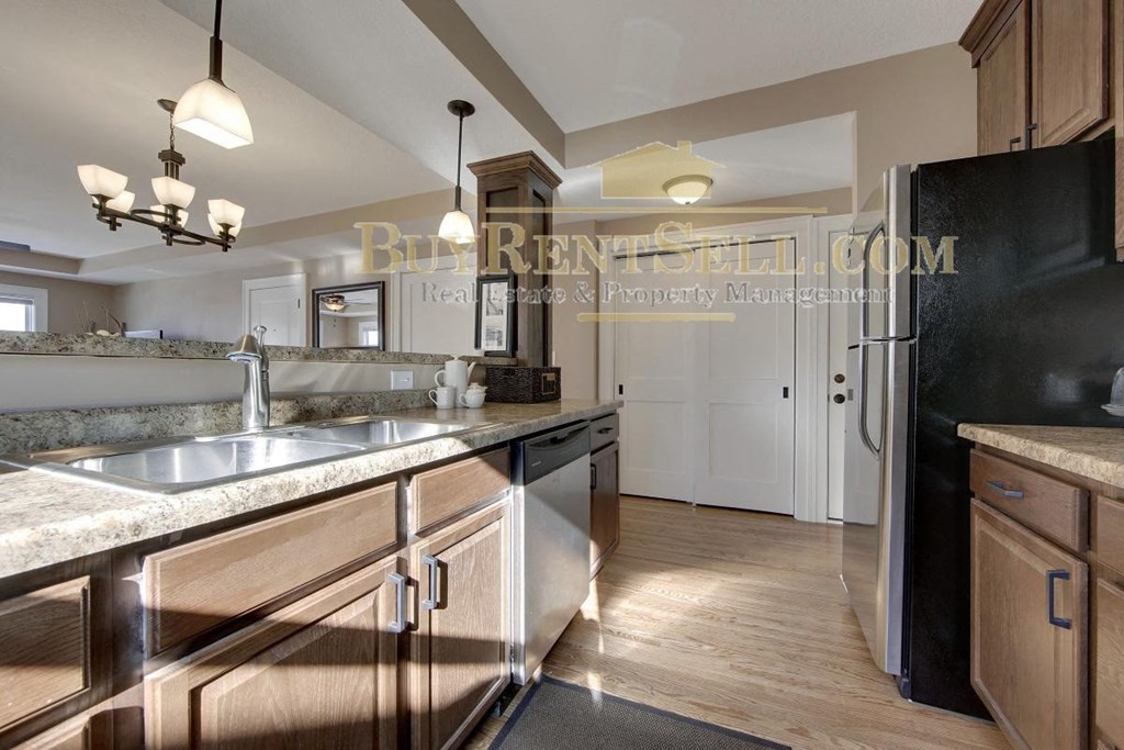 a kitchen with stainless steel appliances and wooden cabinets