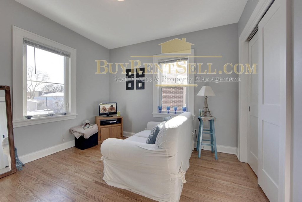 a living room with a white couch and a window