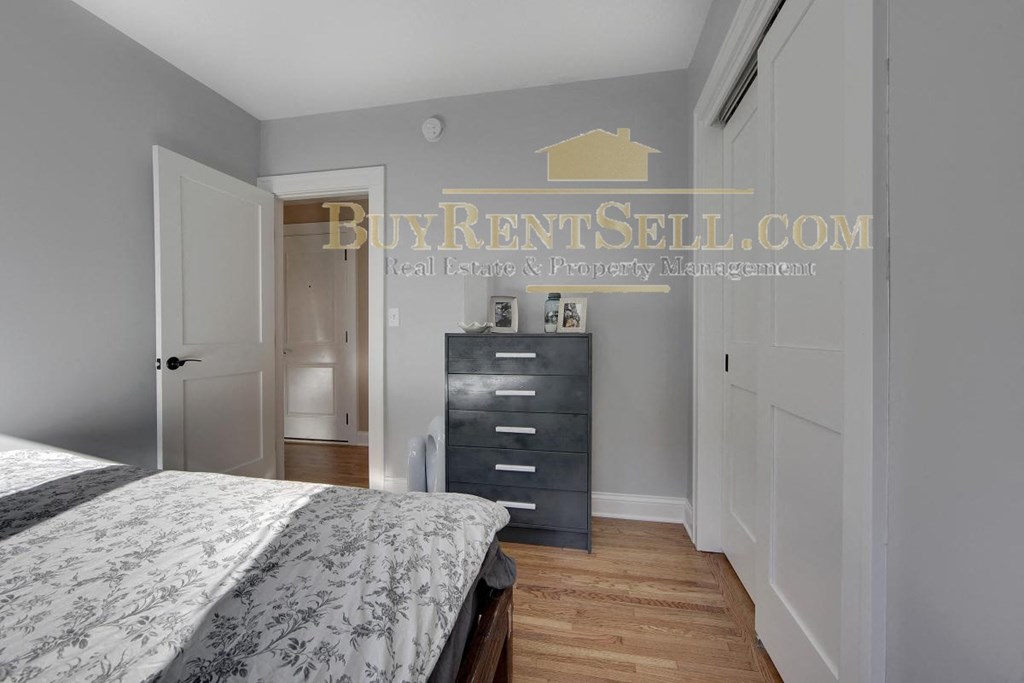 a bedroom with a bed and a dresser