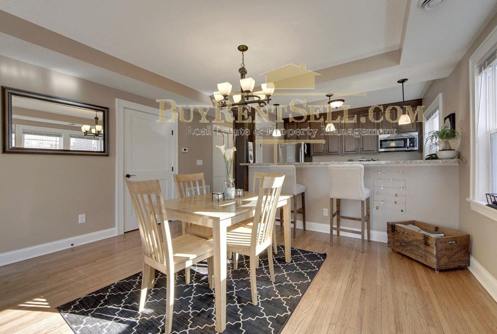 a kitchen and dining room with a table and chairs
