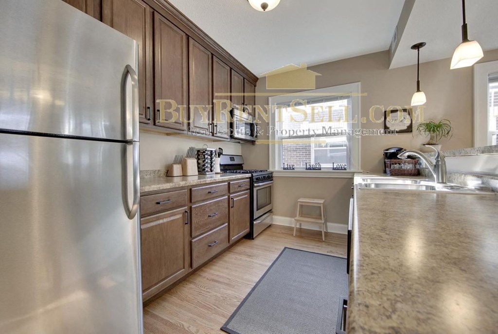 a kitchen with stainless steel appliances and wooden cabinets