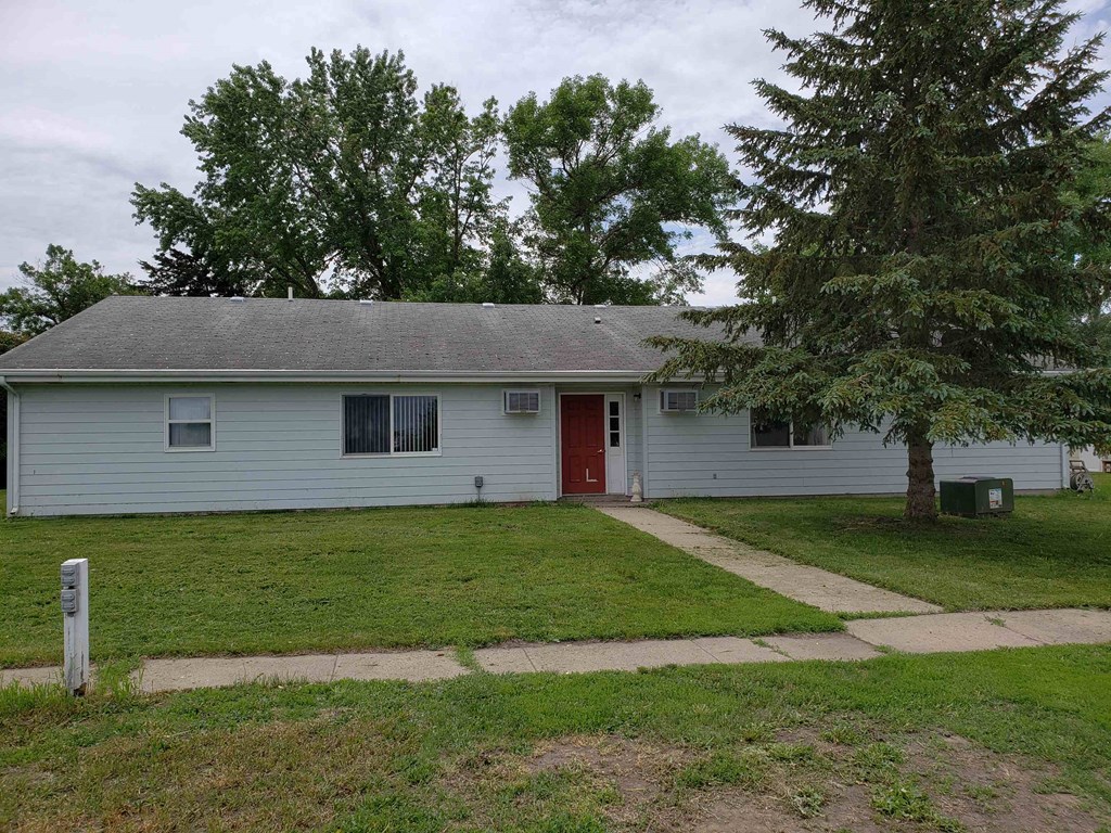 front view of a white house with a red door