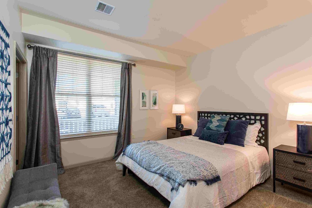 a bedroom with a bed and a window