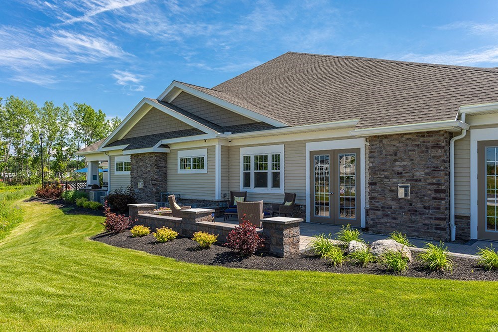 a home with a patio and landscaping in the yard