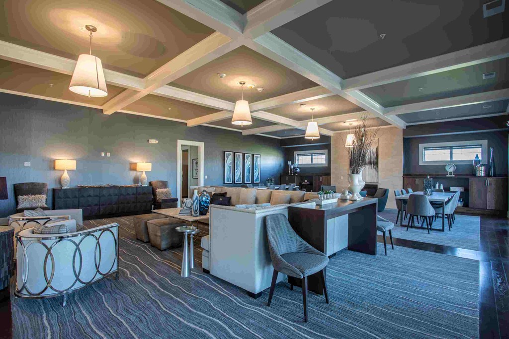 a large living room with couches and tables and chairs