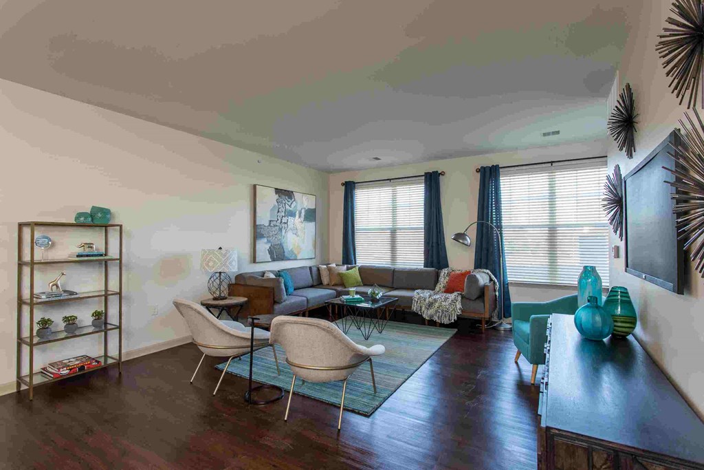 a living room filled with furniture and a large window